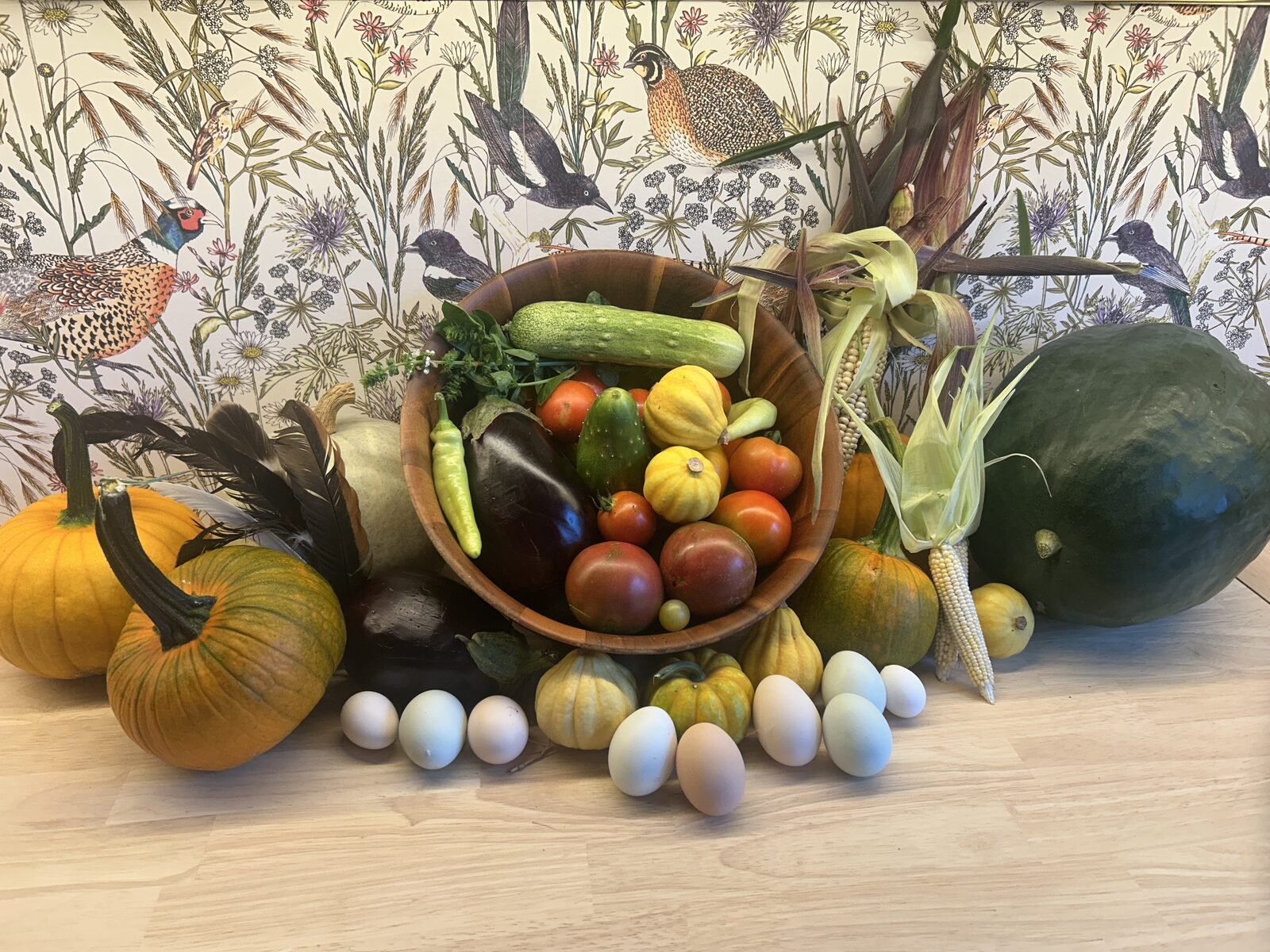 A harvest bowl of eggs and produce from the chicken food forest